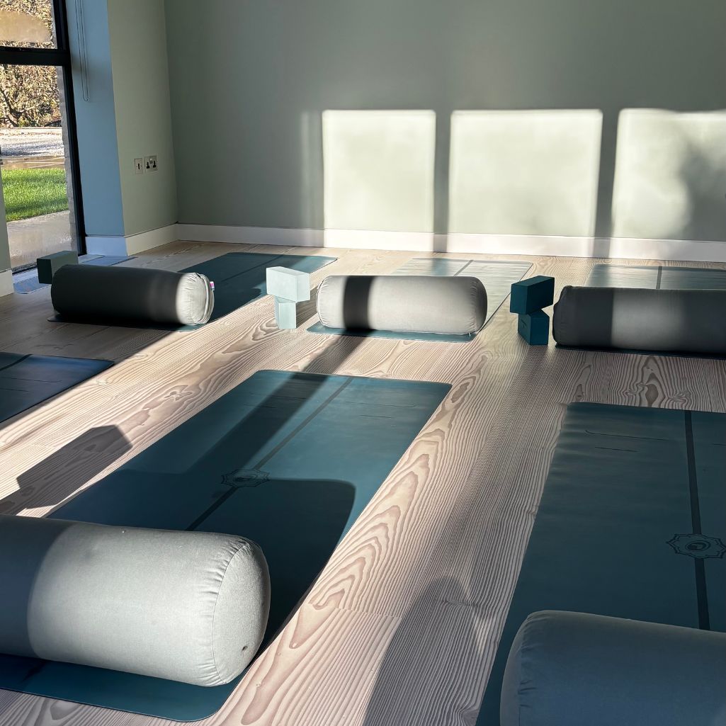 Yoga mats, bolsters and blocks on the floor